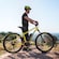 A man standing next to an electric bike on a mountain in France
